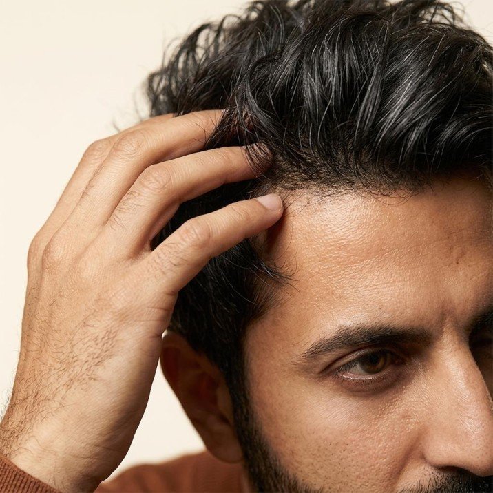 Men touching his hair